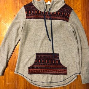 Taupe with orange and blue details hooded top.